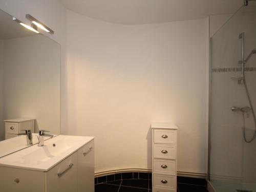 une salle de bain blanche avec un lavabo et une douche dans l'établissement Mont-Dore T3 Duplex avec WIFI et Animaux admis - FR-1-608-26, à Le Mont-Dore
