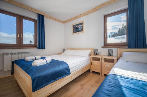 Ένα ή περισσότερα κρεβάτια σε δωμάτιο στο Wierchowe Apartamenty