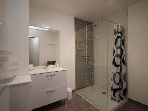 ein Badezimmer mit Dusche, Waschbecken und Spiegel in der Unterkunft Mont-Dore : Somptueux T2 avec WIFI, terrasse et parking - FR-1-608-45 in Le Mont-Dore