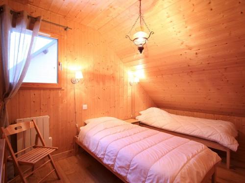a bedroom with two beds in a wooden cabin at Chalet Mont-Dore, 3 pièces, 6 personnes - FR-1-608-65 in Le Mont-Dore