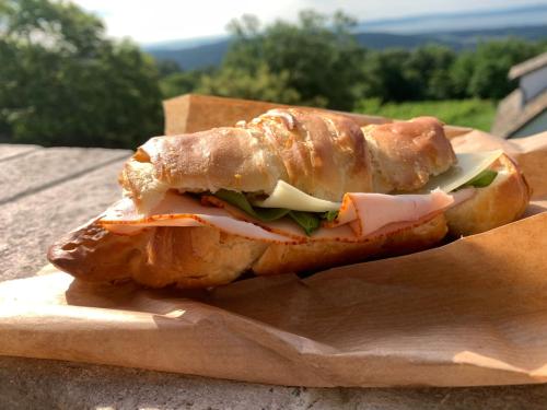 a sandwich sitting on top of a piece of paper at Nagykulcsos Nyúlontúl in Mencshely