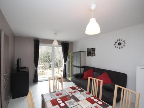 un salon avec une table et un canapé dans l'établissement Le Mont-Dore: Beau T2bis avec terrasse, 2 chambres, WiFi - FR-1-608-70, à Le Mont-Dore
