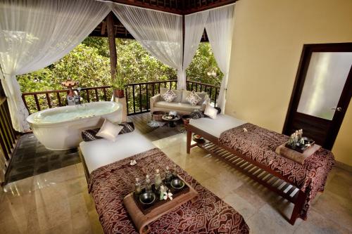 an aerial view of a bathroom with a tub and a bed at Komaneka at Bisma Ubud in Ubud