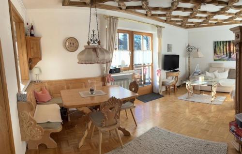 a living room with a table and a dining room at Fewo Christine in Prien am Chiemsee