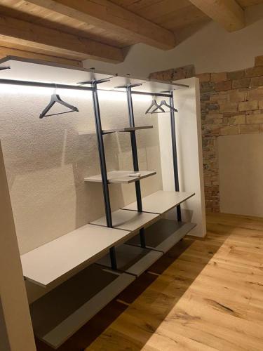 a room with shelves in a room with a brick wall at La Casa nel Relais in Novello