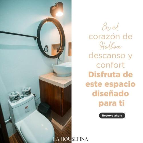 a bathroom with a toilet and a mirror at La HouseFina ground floor 1 in Holbox Island