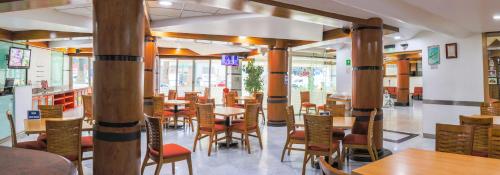 a dining room with wooden tables and chairs at Hotel Palace México in Mexico City