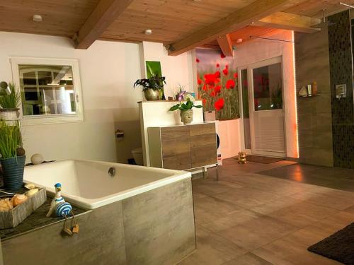 a large bathroom with a bath tub in a room at Ferienwohnung mit Luxusbad, Terrasse Ostseenähe in Gremersdorf