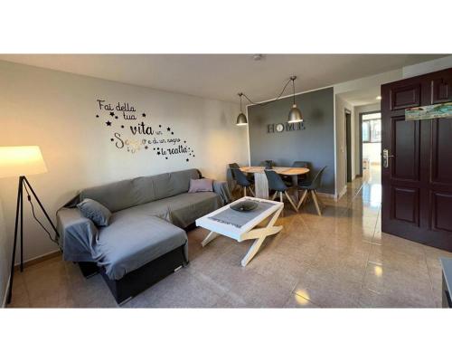 a living room with a couch and a table at Casa Sofia in Corralejo
