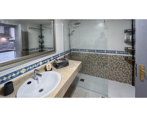 a bathroom with a sink and a mirror at Casa Sofia in Corralejo