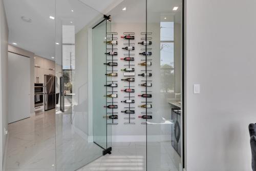 a glass wall with shoes on display in a room at VillaPlaya brand new home, modern style resort! in Fort Lauderdale