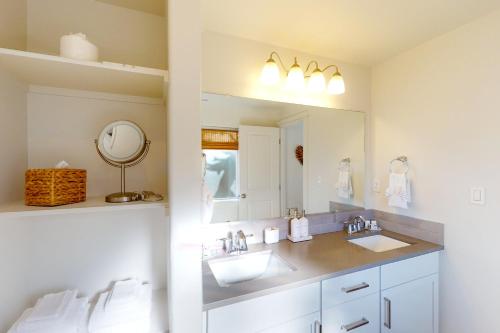 a bathroom with two sinks and a mirror at Turquoise Dreams in Lincoln City