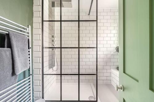 a bathroom with a shower with a glass door at Rumple Cottage in Wingfield