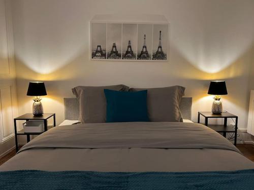 a bedroom with a large bed with two lamps at P&R 2, 2 bedroom, close to center, Plainpalais in Geneva
