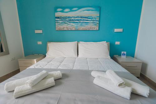 a bedroom with a bed with two towels on it at Panorama Alfeo in Siracusa
