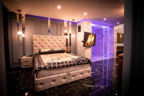 a bedroom with a bed and a fireplace at Spa Lux Apatin in Apatin