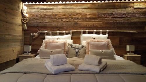 a bedroom with a white bed with a wooden wall at Calme et sérénité 4 étoiles pour vos séjours VSD ou + in Sixt
