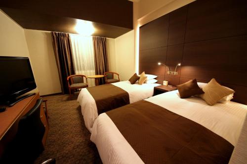 Llit o llits en una habitació de Hotel Miyahira 