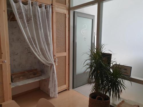 a room with a window and a door with a plant at Aretousa Deluxe Downtown Apartment in Skala