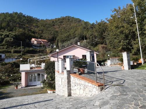a house with a staircase on the side of it at La Civetta - Relax tra verde e mare a 10 minuti da Sestri Levante in Casarza Ligure