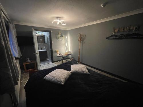 a bedroom with a bed with two pillows on it at Da Vinci Guest House & Guest Parking, A Real Gem in Crawley