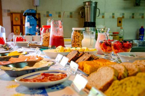 a table with many different types of food on it at Pousada Rancho Das Framboesas in Visconde De Maua