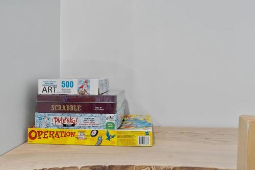 a stack of books sitting on a shelf at Four Peaks - Unit 40A in Collingwood