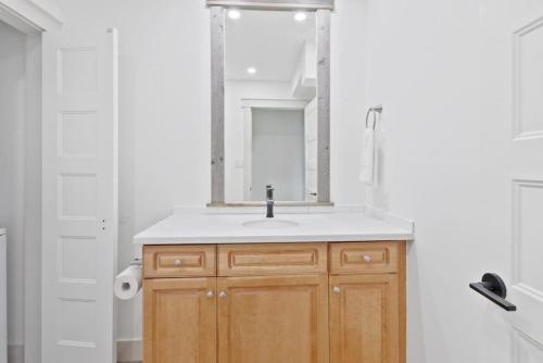 a bathroom with a sink and a mirror at Four Peaks - Unit 40A in Collingwood