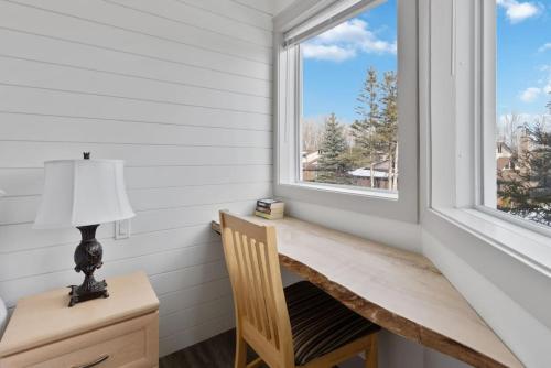a window in a room with a desk and a lamp at Four Peaks - Unit 40A in Collingwood