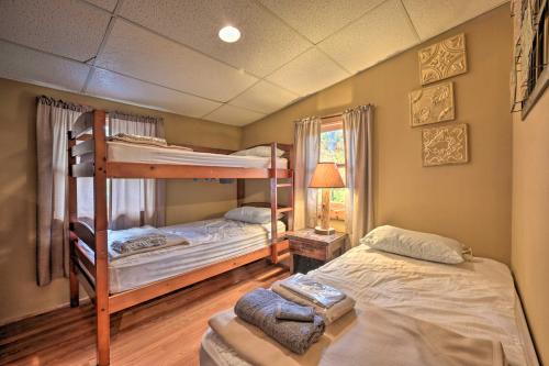 a bedroom with two bunk beds and a chair at James West Apt with 50 Acres - Near Raystown Lake in Huntingdon