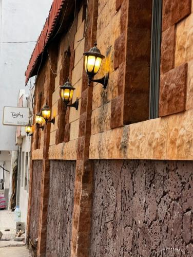 a row of street lights on the side of a building at Hôtel Provençal in Dakar