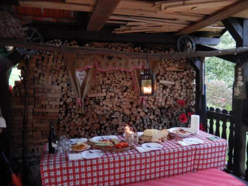 a table with a red and white table cloth with food on it at Apartment Monte Rosa in Delnice