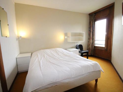 a bedroom with a white bed and a window at Appartement Avoriaz, 2 pièces, 5 personnes - FR-1-633-23 in Avoriaz
