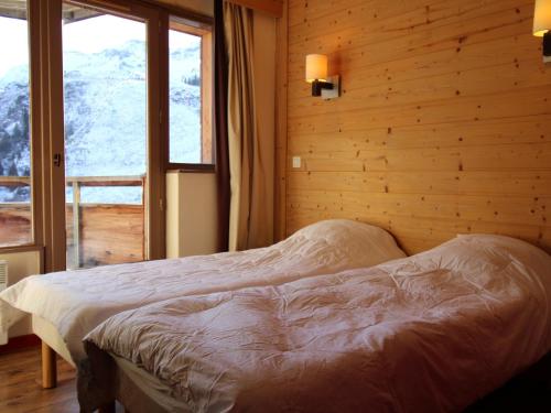 a bedroom with a bed and a large window at Appartement Avoriaz, 4 pièces, 8 personnes - FR-1-633-43 in Morzine