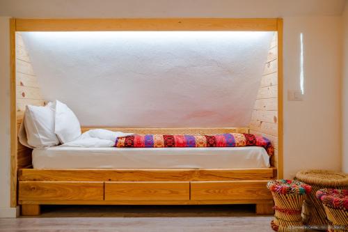 a bedroom with a bed with a window at Dimineți în Cerdac in Piatra Neamţ
