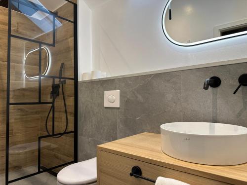 a bathroom with a sink and a mirror at Hotel zur Post Dabringhausen - contactless self check-in in Wermelskirchen