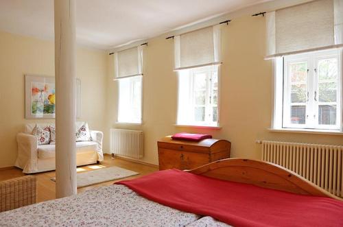 a bedroom with a bed and a living room with windows at Naturerlebnis in Malchin