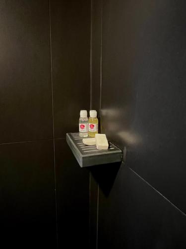 a bathroom stall with two bottles of medicine on a wall at Quinta da Porta - Solar de Vale de Prazeres in Vale de Prazeres