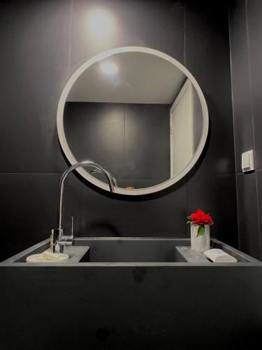 a bathroom with a large mirror and a sink at Quinta da Porta - Solar de Vale de Prazeres in Vale de Prazeres