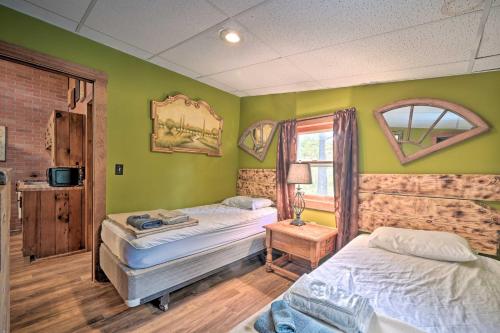 two beds in a room with green walls at Bill Pickett Apt on 50-Acre Ranch - 1 Mi to Lake in Huntingdon