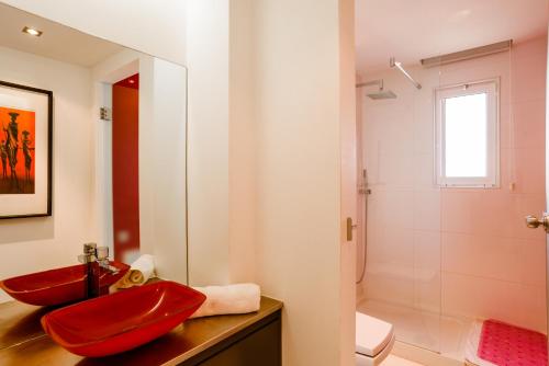 a bathroom with a red sink and a shower at Marina Plaza in Vilamoura