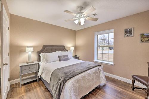 a bedroom with a bed and a ceiling fan at Gorgeous Bentonville Vacation Rental! in Bentonville