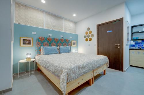 a bedroom with a large bed with a wooden headboard at Sliema Creek Suites in Sliema