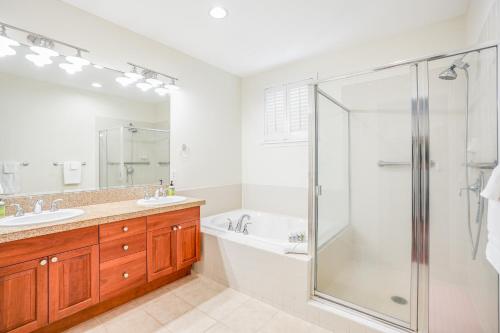 a bathroom with a shower and a tub and a sink at Nihilani 32B in Princeville