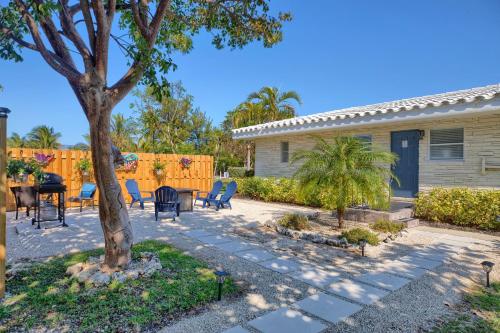 a patio with a table and chairs and a tree at Seascape Resort & Marina in Marathon