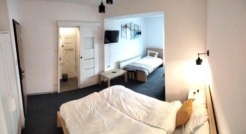 a bedroom with a bed and a small room with a bed sqor at U Gumisia in Korbielów