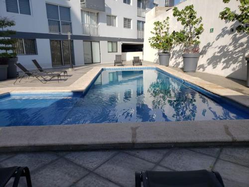 a swimming pool in front of a building at Apartamento Hospicio Cabañas in Guadalajara