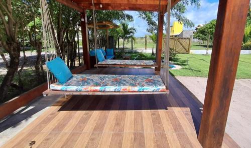 a porch swing with two beds on it at Dalas Village in Marau