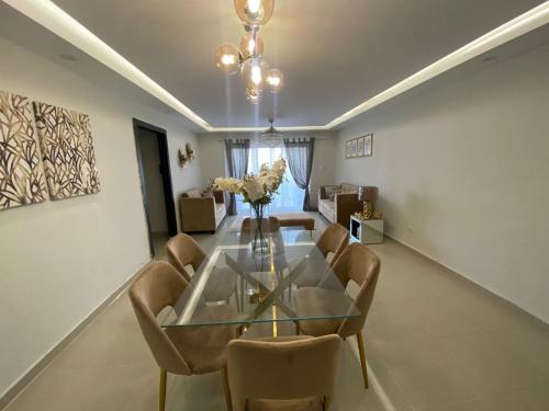 a dining room with a glass table and chairs at Torre catalana in Los Mameyes