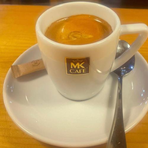 a cup of coffee on a plate with a spoon at Dom Puchacza w Lądku-Zdroju in Lądek-Zdrój
